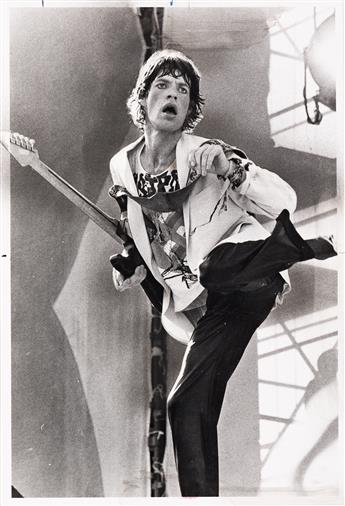 (ROLLING STONES--ROCK AND ROLL) A selection of 13 photographs of the Rolling Stones performing at Soldier Field, Chicago.